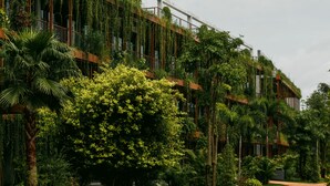 A building with vertical gardens and a pathway. - TUI BLUE Angkor Grace Wellness Resort (Siem Reap)