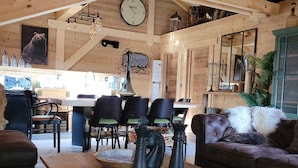 Un intérieur en bois agrémenté d’un échiquier, de meubles en bois et d’une horloge.