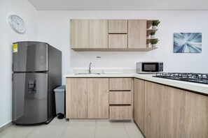 Fridge, microwave, stovetop, coffee/tea maker