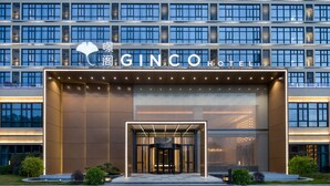 A modern hotel entrance with a prominent sign, a glass door, and a well-lit facade. - GINCO Hotel Guangzhou Baiyun Airport (Guangzhou)