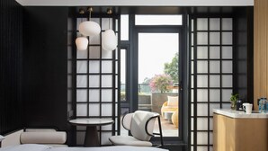 A modern hotel room with a bed, a round table, a chair, and a view of the outdoors through a large window. - GINCO Hotel Guangzhou Baiyun Airport (Guangzhou)