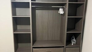 A walk-in closet with multiple shelves, drawers, and hanging space. - French apartment for sale in Aulnay sous bois (Aulnay-sous-Bois)