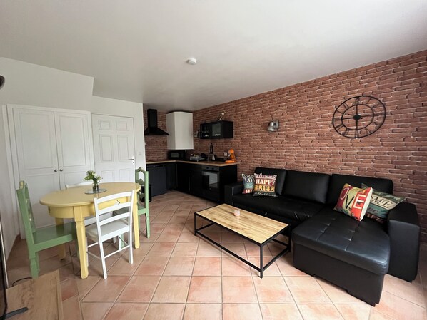 A compact living space with a kitchen, a dining area, and a seating area.