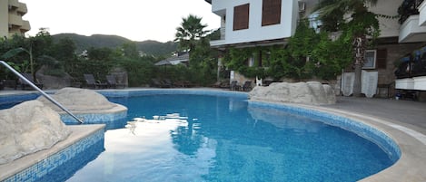 Seasonal outdoor pool, open 10:00 AM to 7:00 PM, pool umbrellas