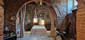 A room with a bed, a chandelier, and a drum set. - The Wishing Well - The Wishing Well (Firenze)