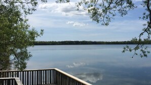 A calm lake with a wooden dock extending into the water. - Jackson's Falls Country Inn (Prince Edward)
