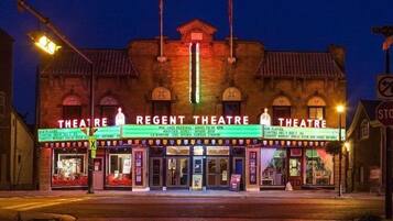 A Regency Theatre building with a marquee displaying various performances.
