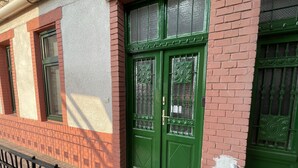 A building with a green door, a window, and a metal fence. - CITY CENTER 1, Fantastic apartment in the city center! (Budapest)