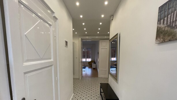 A hallway with patterned flooring, a bench, and a door with a handle. - CITY CENTER 1, Fantastic apartment in the city center! (Budapest)