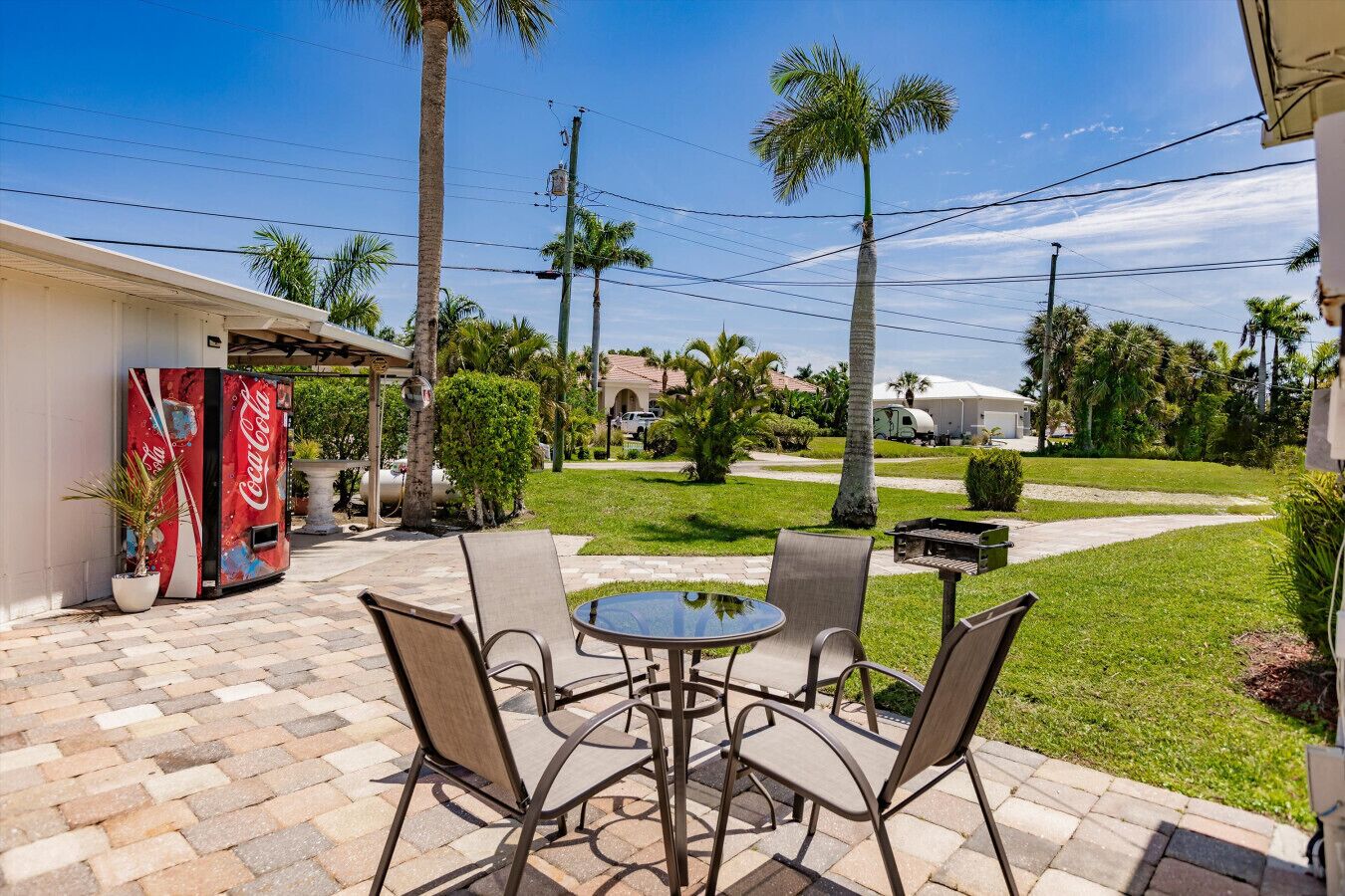 A patio with outdoor seating and a Coca-Cola cooler.