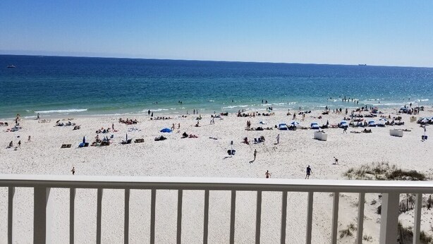 A beach with numerous umbrellas and people. - The Whaler D5 by Liquid Life (Gulf Shores)