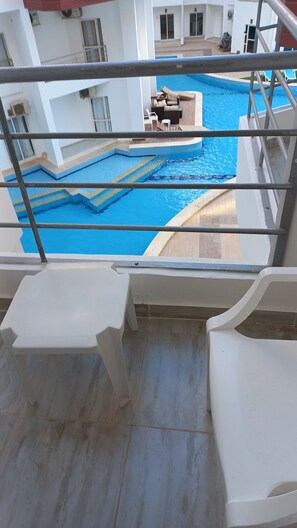 A pool area with a view of the building's interior, including a seating area and a staircase. - Aqua palms resort hurghada  (Hurghada)