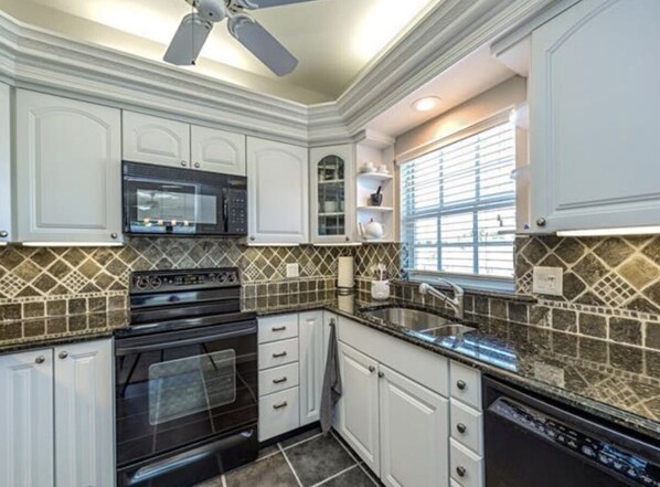 Fridge, microwave, oven, dining tables - Light-filled 2 bedroom/2 bath top floor corner unit in the landmark Colonnade. (Naples)