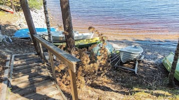 A wooden staircase leading to a dock with several boats.