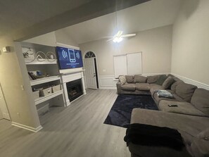 Smart TV, fireplace, books, printers