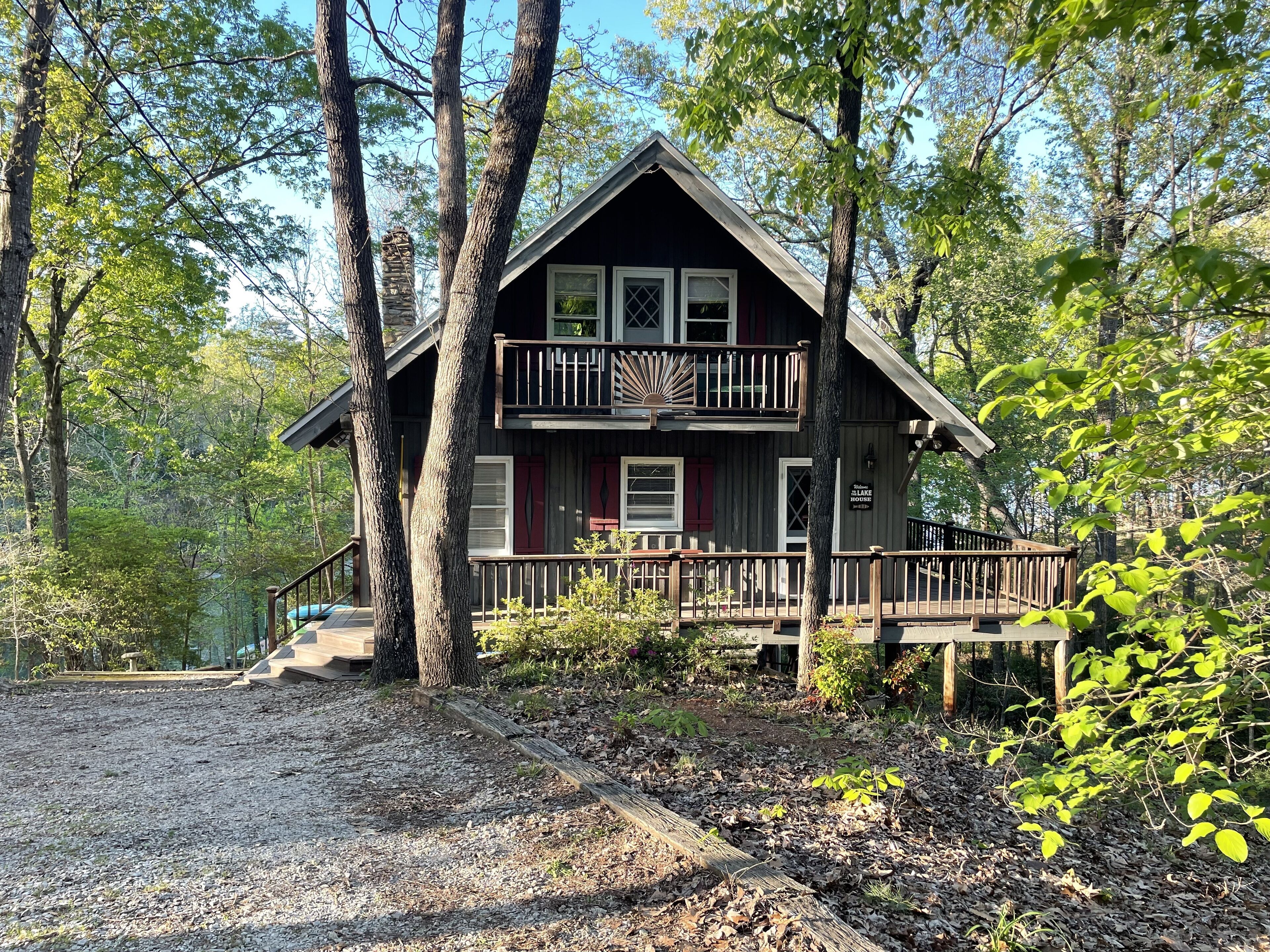 Cozy Cabin with a lower wrap-around porch and two upper porches off bedrooms.