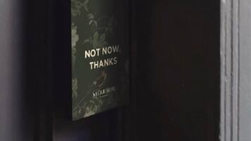 A door with a 'Not Now, Thanks' sign and a keycard reader.