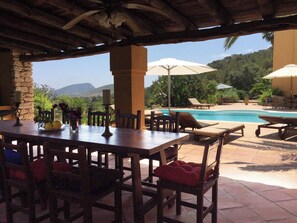 An outdoor dining area with a pool and lounge chairs. - Ibiza-Peacefull Villa with Pool near Ibiza (Santa Eularia del Rio)