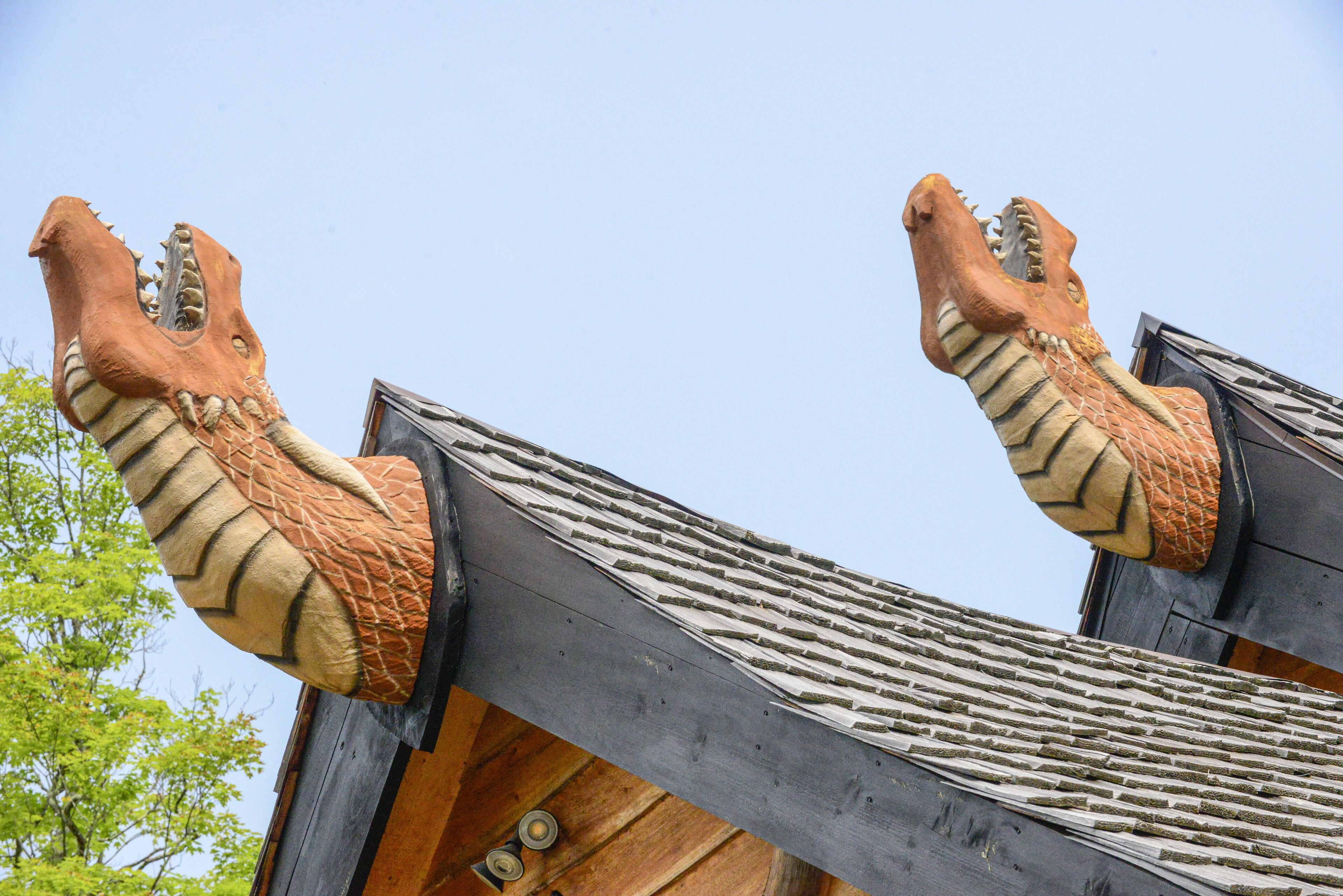 A building with a distinctive roof featuring two large, dragon-like sculptures.