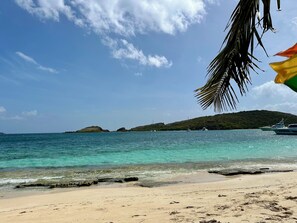 A beach with clear turquoise water, a sandy shore, and a small island in the distance. - Paradise Found In Culebra PR With Incredible Caribbean Sea View (Culebra)