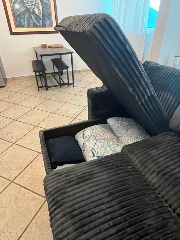 A living room with a sofa, a small table, and a chair. - Paradise Found In Culebra PR With Incredible Caribbean Sea View (Culebra)