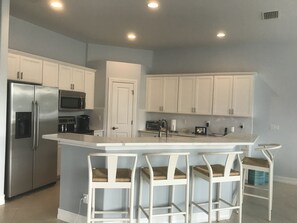 Enjoy cooking in this well-equipped kitchen with a central island and bar stools.