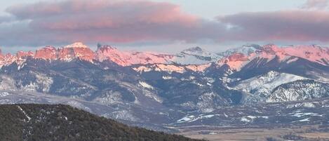 A mountainous landscape with snow-capped peaks and a valley below.