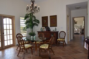 Enjoy meals in this cozy dining area with a glass table and comfortable chairs.
