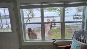 Una habitación con un ventanal grande que da a un muelle y un lago.