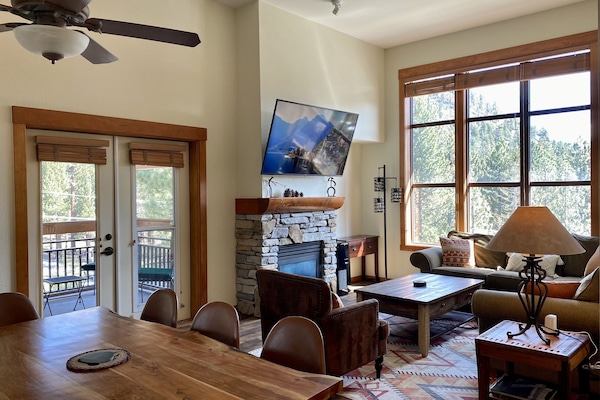 Dining room and living room. Double doors lead to private covered balcony.