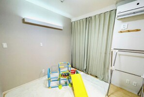 Kids can play and climb in this room's play area with a slide and climbing structure.
