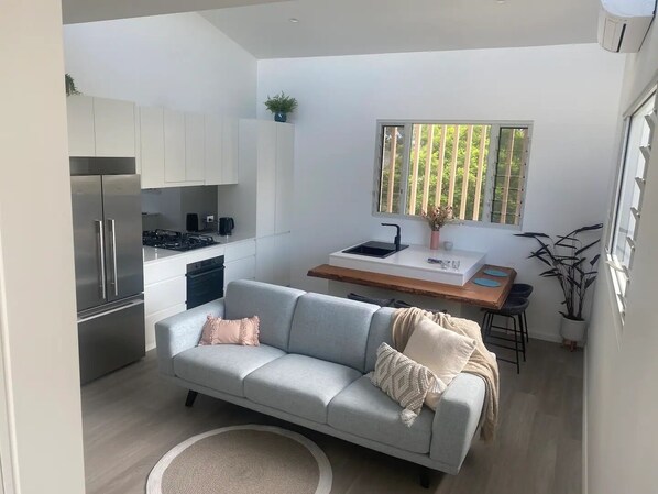 Enjoy a compact yet functional space with a kitchenette, dining area, and comfortable seating area.