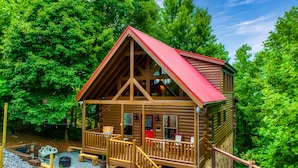 A wooden cabin with a red roof, a porch, and a staircase leading to the entrance. - Stunning Fall Colors From Double Decks, 15 min to Gatlinburg, Firepit, HotTub (Sevierville)