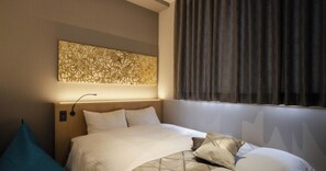 Restful retreat with a comfortable bed and modern art piece.