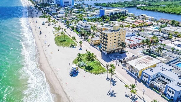 An aerial view of a coastal city with a beach, buildings, and a river. - Beachfront 1BR · Ocean View, Pool + Free Parking (Hollywood)