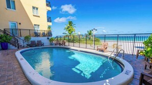 A swimming pool with a view of the beach and ocean. - Beachfront 1BR · Ocean View, Pool + Free Parking (Hollywood)