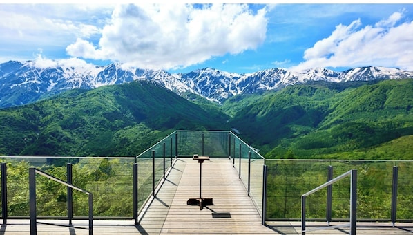 Relax on the deck with a bench and table, taking in the breathtaking views of the surrounding mountains.