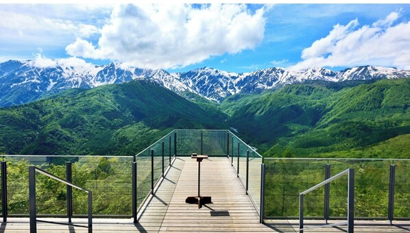 Relax on the deck with a bench and table, taking in the breathtaking views of the surrounding mountains.
