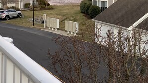 A residential area with houses, a road, and a body of water in the background. - Bethany Bay Beach Oasis, 4 Bed 3 bath, pool, golf, kayak, Ocean View (Ocean View)