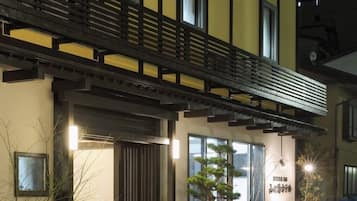 Traditional building with a balcony, garden, and outdoor seating.