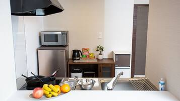 Fridge, microwave, cookware/dishes/utensils, dining tables