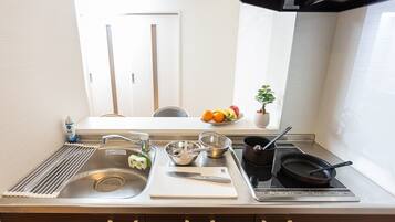 Fridge, microwave, cookware/dishes/utensils, dining tables