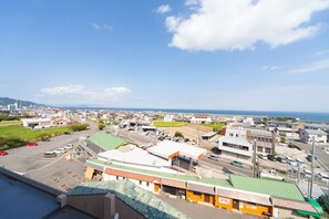 Stroll through the charming coastal town, surrounded by a mix of shops and homes, with the ocean visible in the distance.
