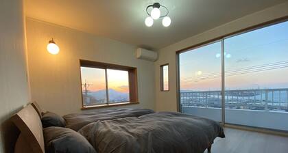 A house with a night view and a healing wood stove - HH / Kitakyushu Fukuoka