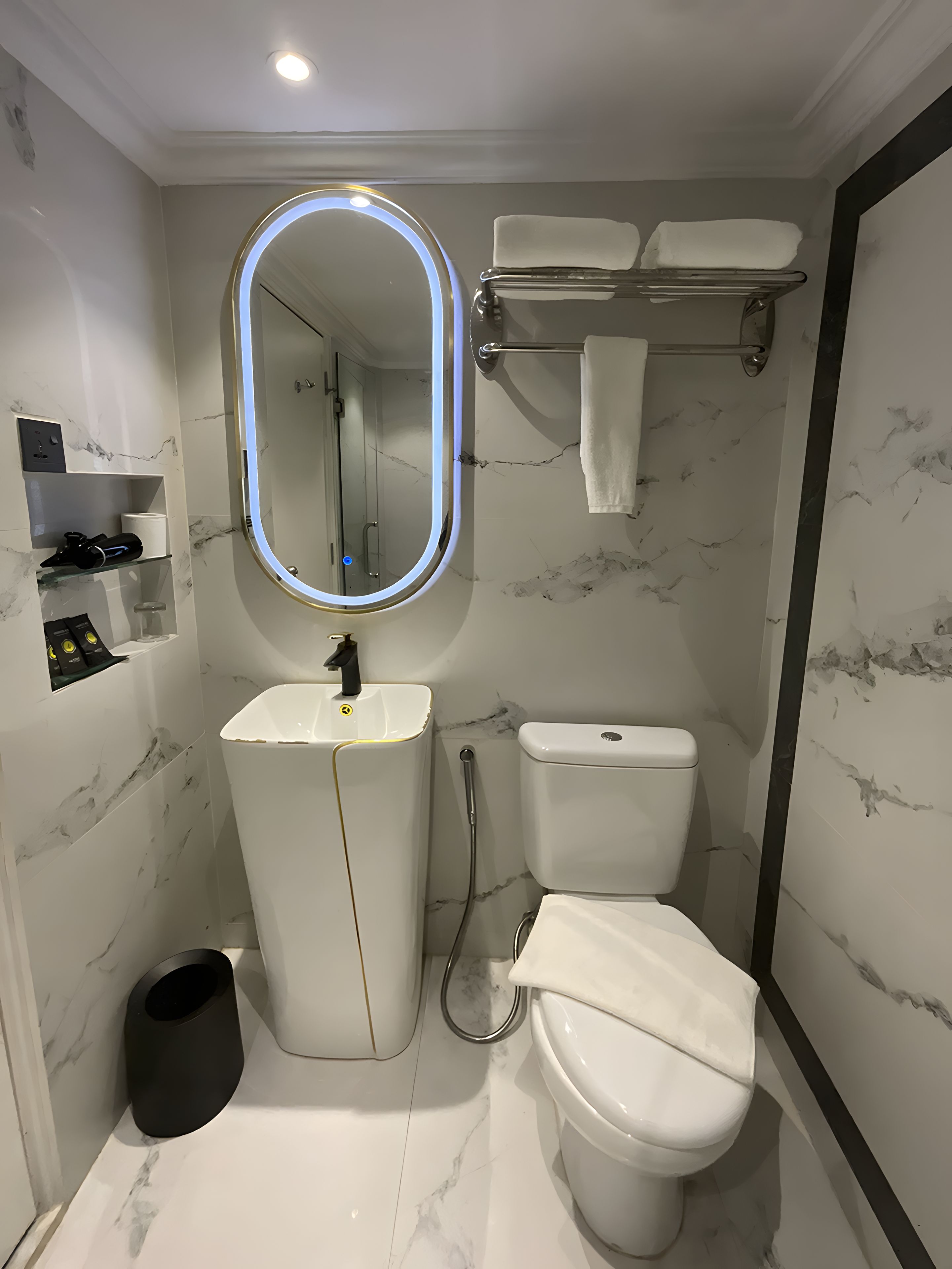 A modern bathroom with a vanity, toilet, and a shower area.