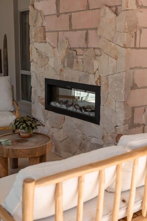 Cozy space with a fireplace and a comfortable seating area.