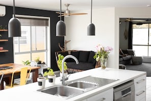 Enjoy meals in the central island kitchen with a dining area and cozy seating space.