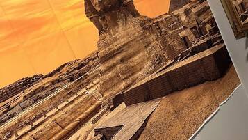 A wall with a large photo of a desert landscape featuring pyramids and a prominent pyramid structure.