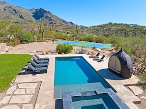 A swimming pool with a stone deck, lounge chairs, and a covered seating area. - Catalina Clubhouse | Pool, Spa, Pickleball & Basketball Court (Tucson)