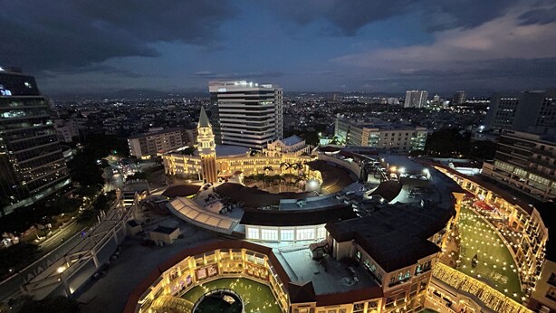 A historic building with a central courtyard, surrounded by modern high-rise buildings. - VenizLex  (Taguig)